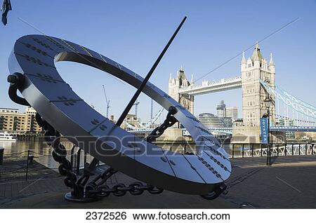 Stock Photograph - A large circular sculpture on the riverbank of the River Thames; London, England. Fotosearch