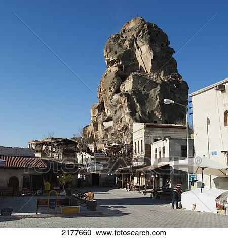 A Large Rock Formation (Castle Of Ortahisar) Against A Blue Sky In An Urban Area; Ortahisar Nevsehir Turkey View Large Photo Image Stock Image - A Large Rock Formation (Castle Of Ortahisar) Against A Blue Sky In An Urban Area; Ortahisar Nevsehir Turkey. Fotosearch