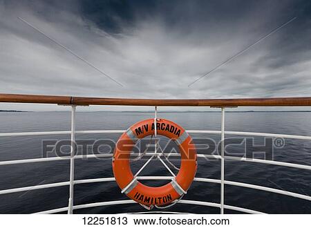A life preserver hanging from the railing on a boat; Norway View Large Photo Image Stock Image - A life preserver hanging from the railing on a boat; Norway. Fotosearch