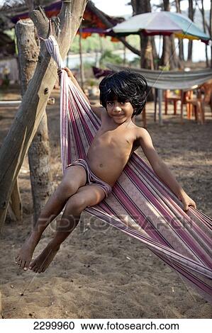 A local child in a hammock, on Turtle Beach, Goa, India. View Large Photo Image Stock Image - A local child in a hammock, on Turtle Beach, Goa, India.. Fotosearch