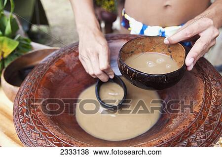 Stock Photo - A local making Awa, a traditional relaxing beverage made from pepper roots; Oahu, Hawaii, United States of America. Fotosearch