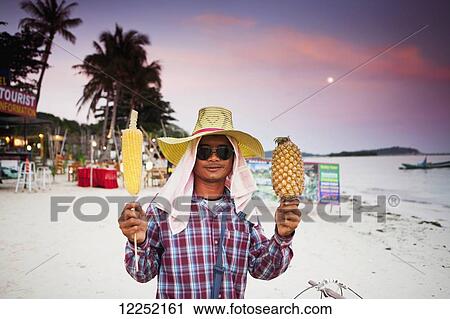 A local vendor selling pineapple and corn on the beach of Chaweng at sunset; Chaweng, Ko Samui, Thailand View Large Photo Image Stock Image - A local vendor selling pineapple and corn on the beach of Chaweng at sunset; Chaweng, Ko Samui, Thailand. Fotosearch