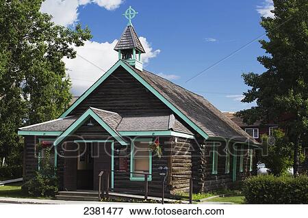 Stock Photo - A log church with a celtic cross on the steeple; Whitehorse, Yukon, Canada. Fotosearch
