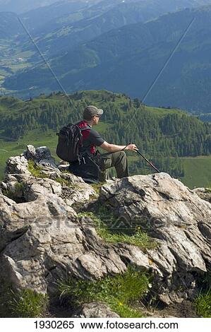 A male hiker enjoys the panoramic view from the Kitzbuheler Horn. Kitzbuehel, Tyrol, Austria. View Large Photo Image Stock Photography - A male hiker enjoys the panoramic view from the Kitzbuheler Horn. Kitzbuehel, Tyrol, Austria.. Fotosearch