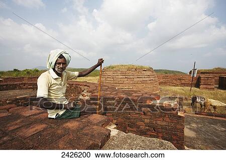 Stock Image - A man at the ruins of the Thotlakonda Buddhist Complex; Visakhapatnam, Andhra Pradesh, India. Fotosearch