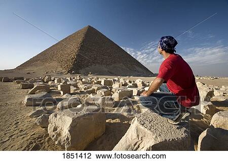 A Man Crouching Near A Pyramid In The Desert View Large Photo Image Stock Image - A Man Crouching Near A Pyramid In The Desert. Fotosearch