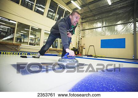 A Man Curling; Naseby, Otago, New Zealand View Large Photo Image Stock Image - A Man Curling; Naseby, Otago, New Zealand. Fotosearch