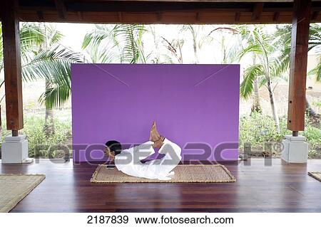 Stock Photo - A man doing a yoga pose, Shanti Ananda Maurice Hotel and Spa; Mauritius. Fotosearch