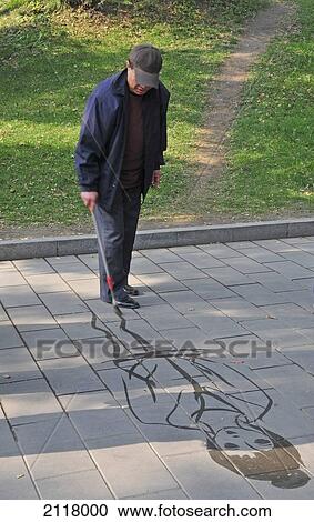 Stock Image - A Man Draws A Picture Of A Woman On A Stone Path; Beijing China. Fotosearch