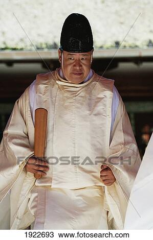 Stock Image - A Man In A Robe In A Ceremony At The Kasuga Grand Shrine; Nara, Nara Prefacture, Japan. Fotosearch