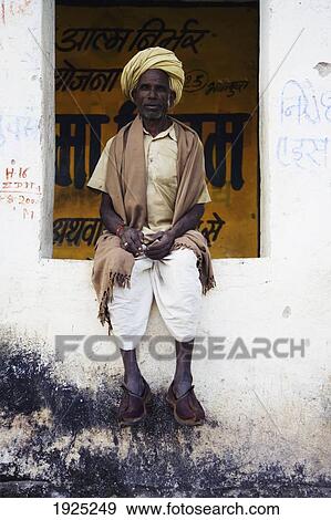 A Man In Clogs Sitting In A Window In Kumbhalgarh, Rajasthan, India View Large Photo Image Stock Photo - A Man In Clogs Sitting In A Window In Kumbhalgarh, Rajasthan, India. Fotosearch