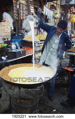 Stock Image - A Man Making Dudh In Handa Jaisalmer, Rajasthan, India. Fotosearch