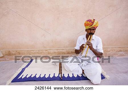 A man playing a musical instrument at Ranvas Palace; Rajasthan, India View Large Photo Image Picture - A man playing a musical instrument at Ranvas Palace; Rajasthan, India. Fotosearch