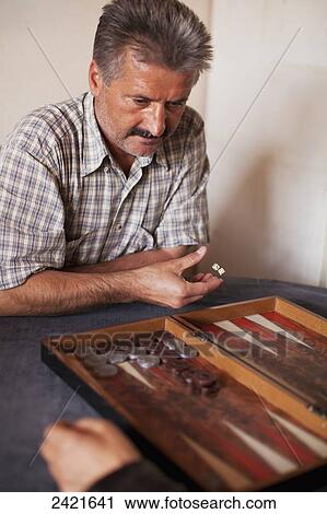 Stock Image - A man playing backgammon; Urgup, Cappadocia, Turkey. Fotosearch