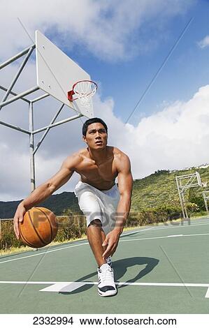 A man playing basketball; Oahu, Hawaii, United States of America View Large Photo Image Picture - A man playing basketball; Oahu, Hawaii, United States of America. Fotosearch