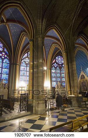 Stock Photo - A Man Praying Inside Notre Dame Du Paris Cathedral, Paris, France. Fotosearch