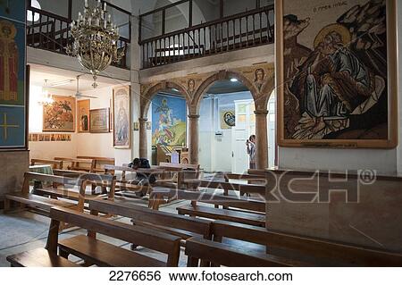 A man prays inside the Greek Orthodox Church of St. George; Madaba, Jordan View Large Photo Image Stock Photograph - A man prays inside the Greek Orthodox Church of St. George; Madaba, Jordan. Fotosearch