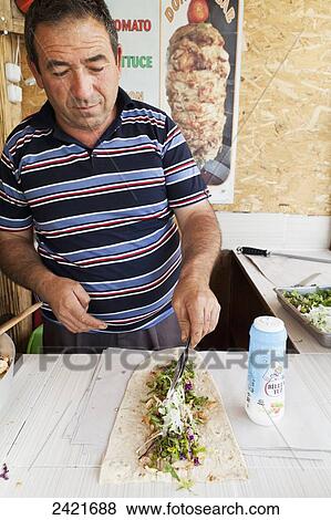 Stock Photo - A man preparing food; Goreme, Cappadocia, Turkey. Fotosearch