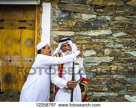 Stock Photo - A man preparing to be photographed; Tabuk, Saudi Arabia. Fotosearch
