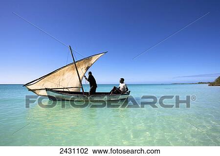 A man raises a sail on an old wooden boat in the Indian Ocean; Vamizi Island, Mozambique View Large Photo Image Stock Image - A man raises a sail on an old wooden boat in the Indian Ocean; Vamizi Island, Mozambique. Fotosearch