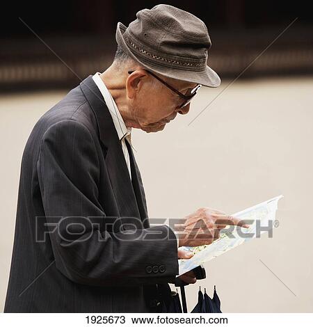 A Man Reading A Map; Tokyo, Japan View Large Photo Image Stock Image - A Man Reading A Map; Tokyo, Japan. Fotosearch
