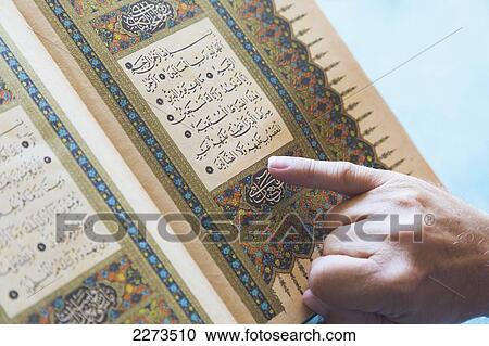 A man reading from the koran with his finger pointing to the text; turkey View Large Photo Image Stock Image - A man reading from the koran with his finger pointing to the text; turkey. Fotosearch