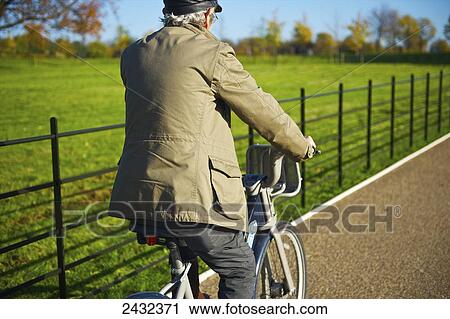 A man rides his bicycle on a gravel path in Hyde Park; London, England View Large Photo Image Stock Image - A man rides his bicycle on a gravel path in Hyde Park; London, England. Fotosearch