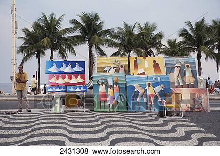 A man selling paintings beside Copacabana beach, with patterned cobblestones on the pavement; Rio de Janeiro, Brazil View Large Photo Image Stock Photo - A man selling paintings beside Copacabana beach, with patterned cobblestones on the pavement; Rio de Janeiro, Brazil. Fotosearch