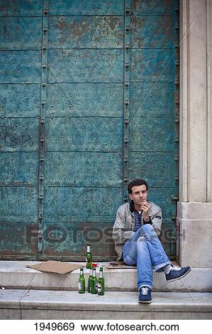 A Man Sits On The Steps With Many Beer Bottles Beside Him; Venice Venezia Italy View Large Photo Image Stock Photo - A Man Sits On The Steps With Many Beer Bottles Beside Him; Venice Venezia Italy. Fotosearch