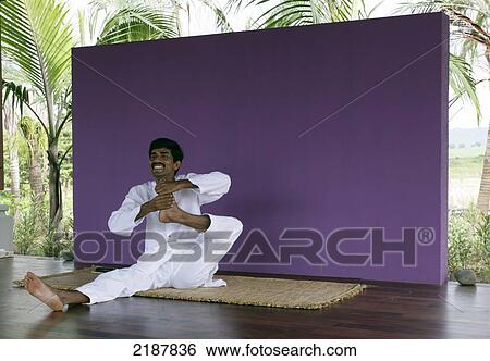 A man sitting in a stretching pose, Shanti Ananda Maurice Hotel and Spa; Mauritius View Large Photo Image Stock Photograph - A man sitting in a stretching pose, Shanti Ananda Maurice Hotel and Spa; Mauritius. Fotosearch