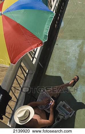 A Man Sitting On The Seafront Reading The Newspapers On A Sunny Day. Broadstairs, Kent. England. Uk. Photo View Large Photo Image Stock Image - A Man Sitting On The Seafront Reading The Newspapers On A Sunny Day. Broadstairs, Kent. England. Uk. Photo. Fotosearch