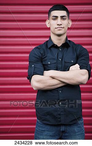 A man standing in front of a red wall; San Francisco, California, USA View Large Photo Image Stock Photo - A man standing in front of a red wall; San Francisco, California, USA. Fotosearch