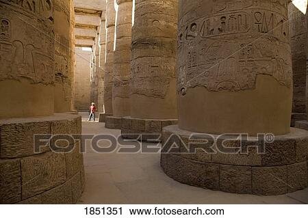 Stock Image - A Man Standing In The Temple Of Karnak; Luxor, Egypt. Fotosearch