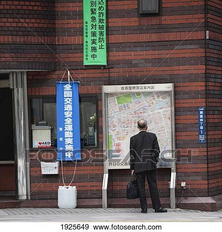 A Man Stands Looking At A City Map; Tokyo, Japan View Large Photo Image Stock Photo - A Man Stands Looking At A City Map; Tokyo, Japan. Fotosearch