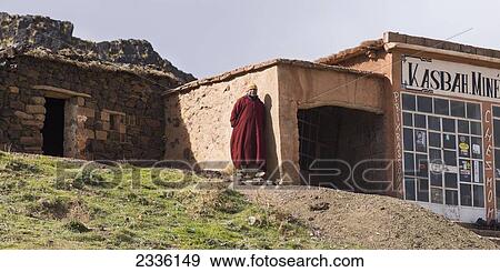 Stock Photo - A Man Stands Outside A Shop; Morocco. Fotosearch