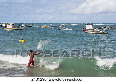 A man throws a fishing net from the beach at Porto de Galinhas; Pernambuco, Brazil View Large Photo Image Stock Image - A man throws a fishing net from the beach at Porto de Galinhas; Pernambuco, Brazil. Fotosearch