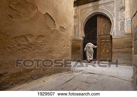 A man walks into a horseshoe shaped doorway; Fez, Morocco View Large Photo Image Stock Photo - A man walks into a horseshoe shaped doorway; Fez, Morocco. Fotosearch