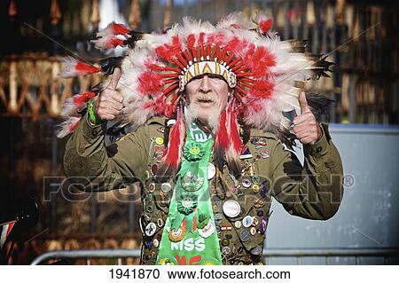 Stock Image - A Man Wearing A Feather Headdress For The Saint Patrick's Day Parade; Dublin Ireland. Fotosearch