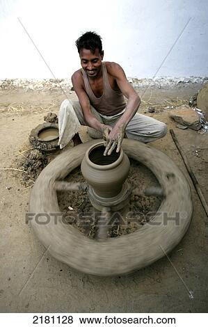 A man working on a pottery wheel, Potters village; Madhya Pradesh, India View Large Photo Image Stock Photo - A man working on a pottery wheel, Potters village; Madhya Pradesh, India. Fotosearch