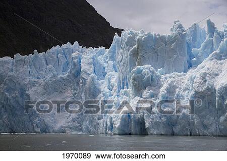 Stock Photo - A Mass Of Ice Calves From The San Rafael Glacier Into Laguna San Rafael, Laguna San Rafael National Park, Aysen Region, Chile. Fotosearch