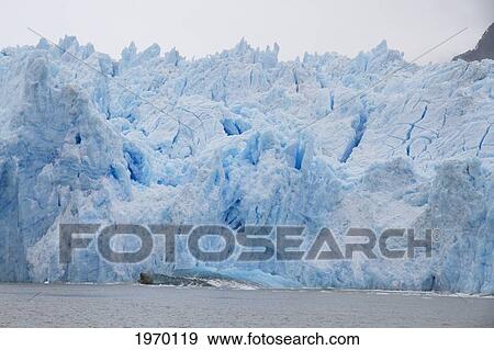 A Mass Of Ice Calves From The San Rafael Glacier Into Laguna San Rafael, Laguna San Rafael National Park, Aysen Region, Chile View Large Photo Image Stock Photo - A Mass Of Ice Calves From The San Rafael Glacier Into Laguna San Rafael, Laguna San Rafael National Park, Aysen Region, Chile. Fotosearch