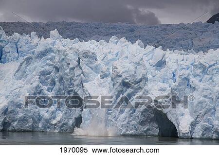 Stock Photography - A Mass Of Ice Calves From The San Rafael Glacier Into Laguna San Rafael, Laguna San Rafael National Park, Aysen Region, Chile. Fotosearch