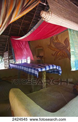 A massage table covered in cloth with red decorative fabric draped from the ceiling; Ulpotha, Embogama, Sri Lanka View Large Photo Image Stock Photography - A massage table covered in cloth with red decorative fabric draped from the ceiling; Ulpotha, Embogama, Sri Lanka. Fotosearch