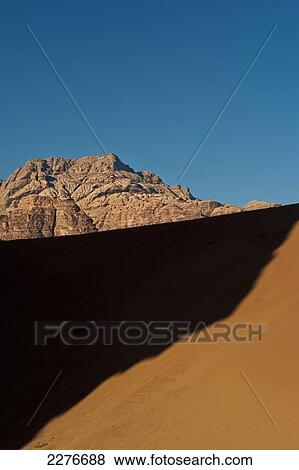 Stock Photo - A maze of monolithic rockscapes rising up from the desert floor, Wadi Rum; Jordan. Fotosearch