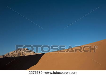 Stock Photo - A maze of monolithic rockscapes rising up from the desert floor, Wadi Rum; Jordan. Fotosearch