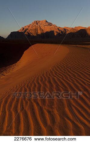 Stock Photograph - A maze of monolithic rockscapes rising up from the desert floor, Wadi Rum; Jordan. Fotosearch