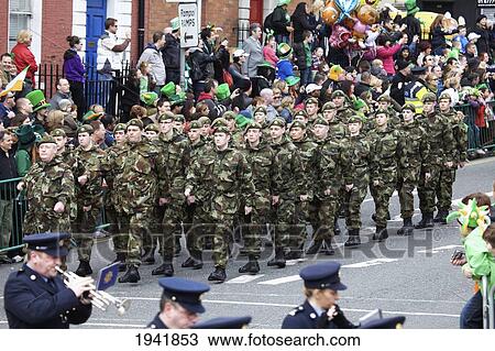 Stock Image - A Military March And Marching Band In The Saint Patrick's Day Parade; Dublin Ireland. Fotosearch