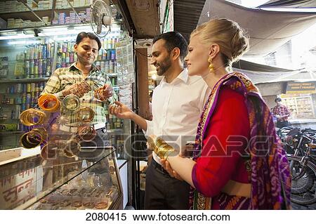Stock Photography - A Mixed Race Couple Shopping For Jewelry; Ludhiana, Punjab, India. Fotosearch