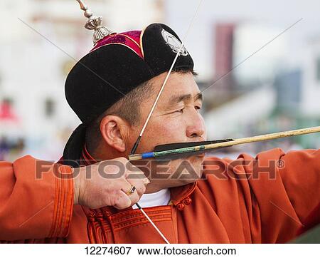 Stock Photo - A Mongolian archer competes at the 2014 Naadam Mongolian National Festival in the archery field by the National Sports Stadium, Ulaanbaatar (Ulan Bator), Mongolia. Fotosearch