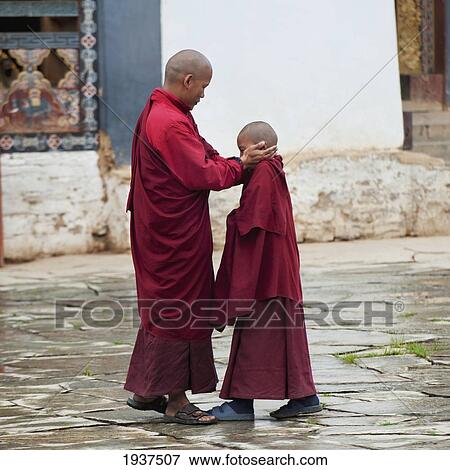 A Monk Places His Hands On The Head Of A Novice Monk At Gangte Goemba Monastery; Bhutan View Large Photo Image Stock Photo - A Monk Places His Hands On The Head Of A Novice Monk At Gangte Goemba Monastery; Bhutan. Fotosearch